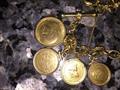 18 Kt gold charm bracelets with 22kt   24 kt gold coin 